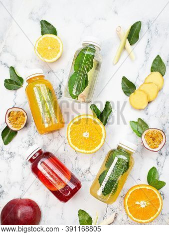 Natural Lemonade With Fruits On Marble Table. Orange, Passion Fruir, Lemon, Ginger.