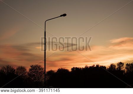 Horizontal Landscape Picture With A Silhouette Of An Isolated High Turned Off Street Lamp On The For