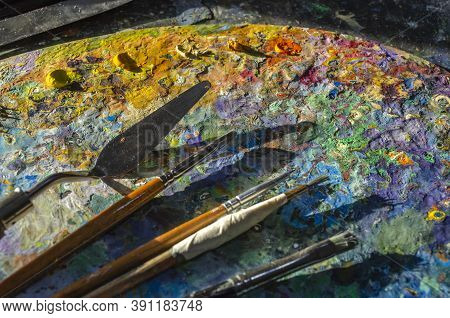 Painter Palette With Colours And Brushes