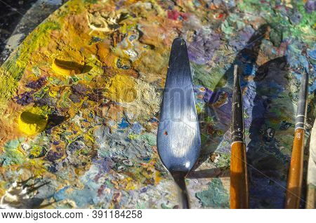 Painter Palette With Colours And Brushes