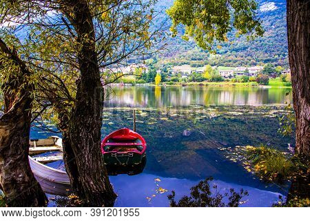 Romantically Abandoned Red And White Boats On The Shores Of The Revine Lakes, Treviso, Italy