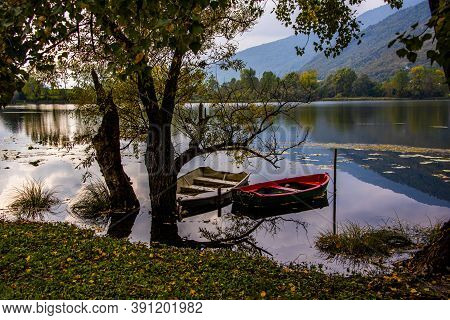 Romantically Abandoned Red And White Boats On The Shores Of The Revine Lakes, Treviso, Italy