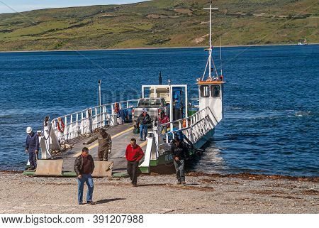 Punta Arenas, Chile - December 12, 2008: Green-white Ferry Sits On Blue Water Otway Sound After Land