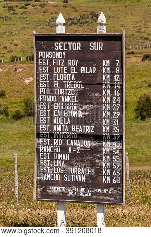 Riesco Island, Chile - December 12, 2008: White On Brown Wooden Sign Listing Farms And Homesteads In