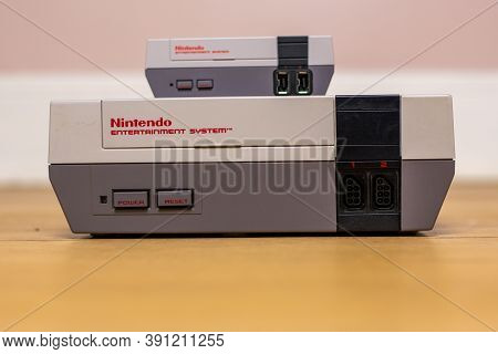 A Nintendo Entertainment System Classic Edition On Top Of An Original Nintendo Entertainment System,