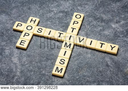 hope, positivity and optimism crossword in ivory letter tiles against textured paper, positive mindset concept