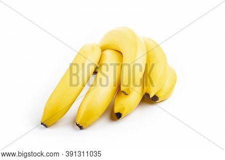 Shooting In The Studio. A Branch Of Ripe Yellow Bananas In A Peel. On White Background. Close-up
