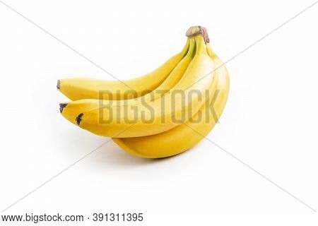 Shooting In The Studio. A Branch Of Ripe Yellow Bananas In A Peel. On White Background. Close-up
