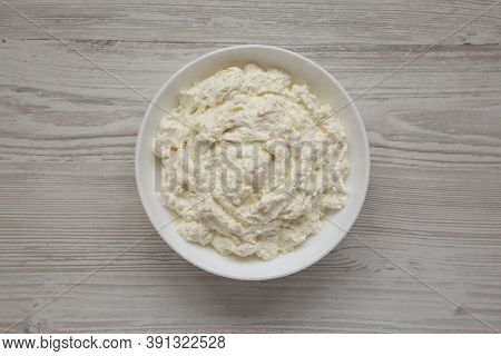 Tasty Ricotta Cheese In A White Bowl, Top View. Overhead, From Above, Flat Lay.