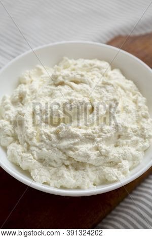 Tasty Ricotta Cheese In A White Bowl, Low Angle View. Close-up.