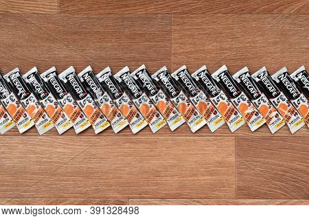 Many Nescafe Caramel Cream Coffee Sticks On Wooden Background. Nescafe Is A Brand Of Coffee Made By 