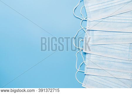 Blue Antiviral Medical Face Masks. Surgical Protective Masks With Ear Loops On Blue Background.