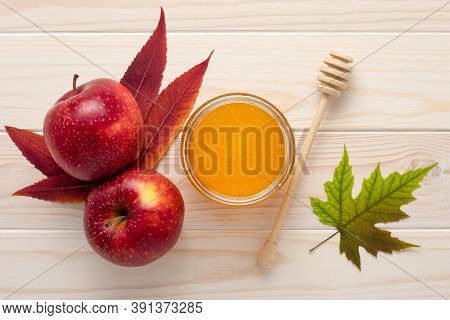 Honey In A Glass Jar And Red Apples On A White Wooden Background. Celebration Rosh Hashanah, Full Ye
