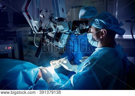 A Team Of Surgeons Performing Brain Surgery To Remove A Tumor.