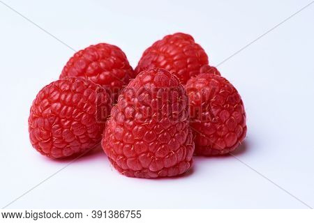 A Bunch Of Raspberries On A White Background