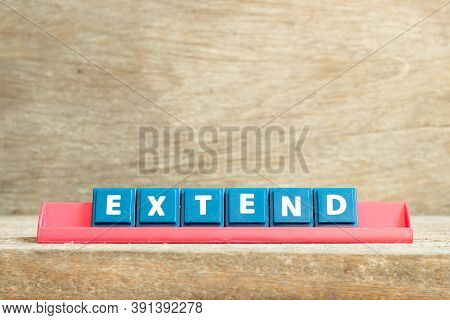 Tile Letter On Red Rack In Word Extend On Wood Background