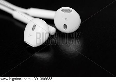 White Earphones On Black Background. Copy Space. Music Is My Life Concept. Earbuds Or Earphones On B