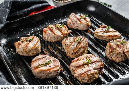 Grilled Pork Tenderloin Medallions With Fresh Herbs In A Pan. Gray Background. Top View