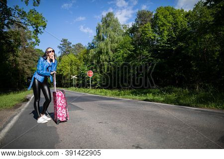 A Young Girl Stops By Hitchhiking To Shorten The Travel Time To The Arranged One. A Hot Day Can Be F