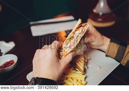 The Young Man Happily Prepares To Eat A Juicy Veggie Sandwich. Sandwich Close Up, Visible Chickpea C