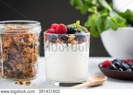 Yogurt Granola Parfait With Berries. Greek Yogurt With Oat Honey Granola, Raspberries And Blueberrie
