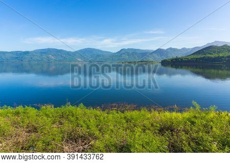 View Of Reservoir Blue Sky And Green Grass