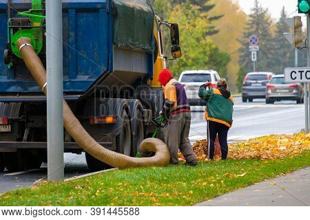 Moscow. Russia. October 11, 2020. Utility Workers Remove Yellow Autumn Leaves With An Industrial Vac