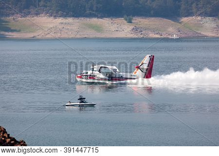Lost Creek Lake Near Prospect,  Oregon / Usa - September 7, 2014:  A Small Fire Fighting Plane Skims