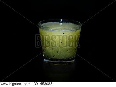 Green Kiwi Smoothie In Glass On Black Background