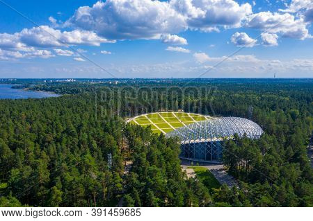 Riga, Latvia. August 10, 2020. Beautiful New Stadium Located In The Middle Of A Forest. Aerial View 