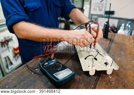 Marine Electrical Engineer Officer In Engine Control Room Ecr. He Works In Workshop