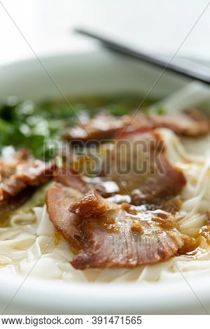 Side View Bowl Of Bbq Prok With Rice Noodles Vertical Composition