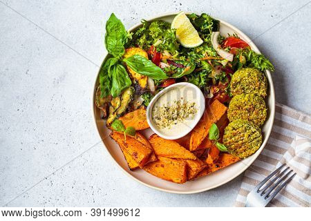 Falafel Salad Bowl. Vegan Lunch Plate - Baked Chickpea Cutlets With Baked Sweet Potatoes And Vegetab