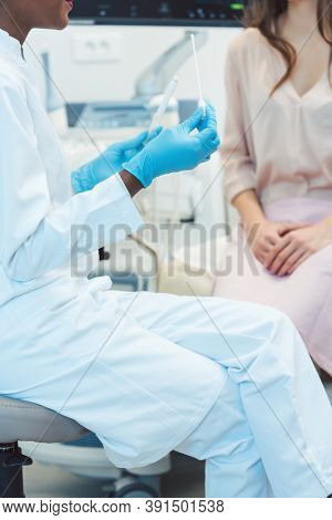 Gynecologist testing vaginal swab for STD, close-up