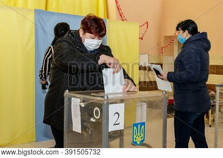 Velyka Dobron, Ukraine - October 25, 2020: Voters Wearing Protective Masks Vote In Local Elections D