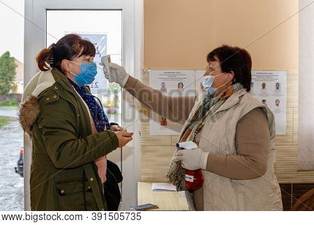 Velyka Dobron, Ukraine - October 25, 2020: Temperature Screening Of Voters Before Voting In Local El