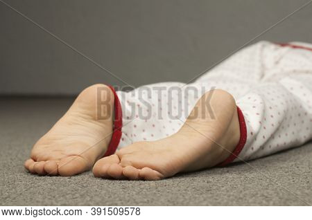 Legs Of A Child 8-10 Years Old In Pajamas. Foot