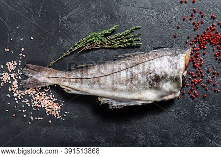 Raw Haddock Fish Without A Head. Black Background. Top View