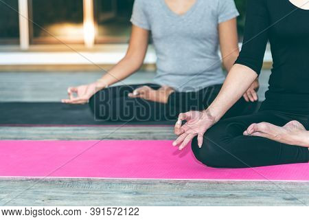 Two Women Are Practicing Yoga In The Basic Position, Which Is A Warm-up And Meditation Exercise, Con