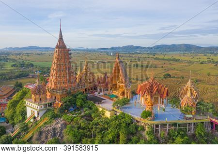 Aerial View Of Big Golden Buddha Statue And Pagoda In Tiger Cave Temple Or Wat Tham Suea In Kanchana