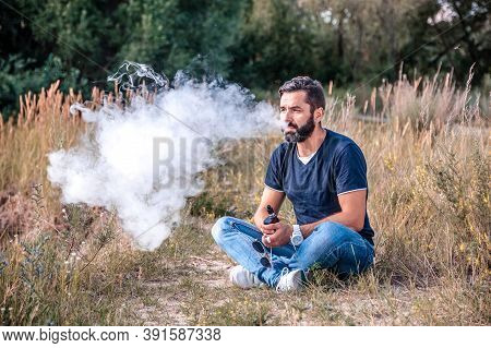Handsome Vape Man Smoking An Vape. Getting Rid Of Nicotine Addiction.