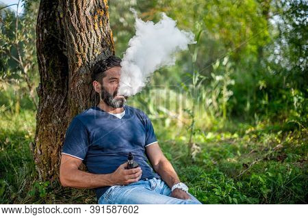 Bearded Vaper Blows Up A Couple An E-cigarette. Vaping.
