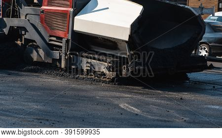Industrial Asphalt Paver Machine Laying Fresh Asphalt On Road Construction Site On The Street. A Pav