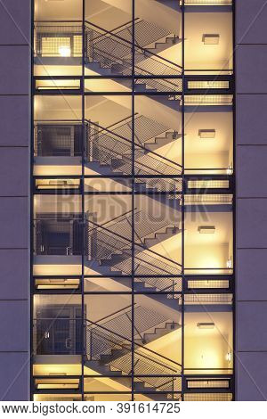 Empty Stairwell With Staircase Illuminated Inside Modern Housing Block Viewed From Outside Through G
