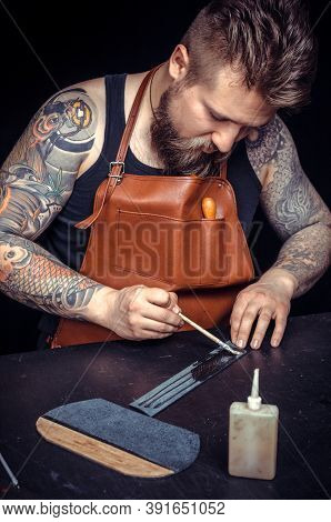 Leather Craftsman Works With Leather In His Workshop