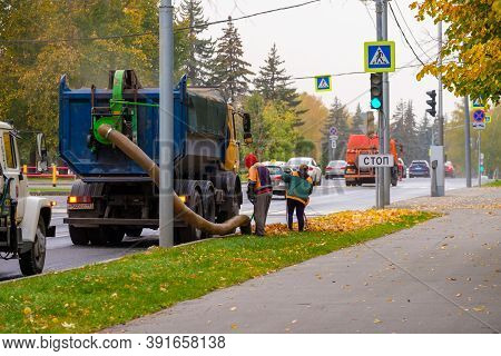 Moscow. Russia. October 11, 2020. Utility Workers Remove Yellow Autumn Leaves With An Industrial Vac