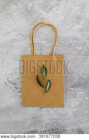 Sustainable Consumer Choices, Shopping Bag And Leaves On Concrete Background