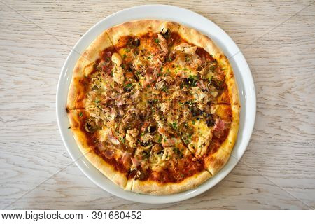 Baked Pizza With Mushrooms, Bacon And Cheese In A White Dish On A Light Wooden Table. Top View. Pizz