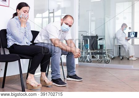 Upset Couple In Hospital Waiting Room After Bad News From Medical Stuff. Doctor Giving Unfavorable T