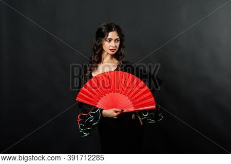 Portrait Of Beautiful Young Woman Dancing Flamenco In Studio
